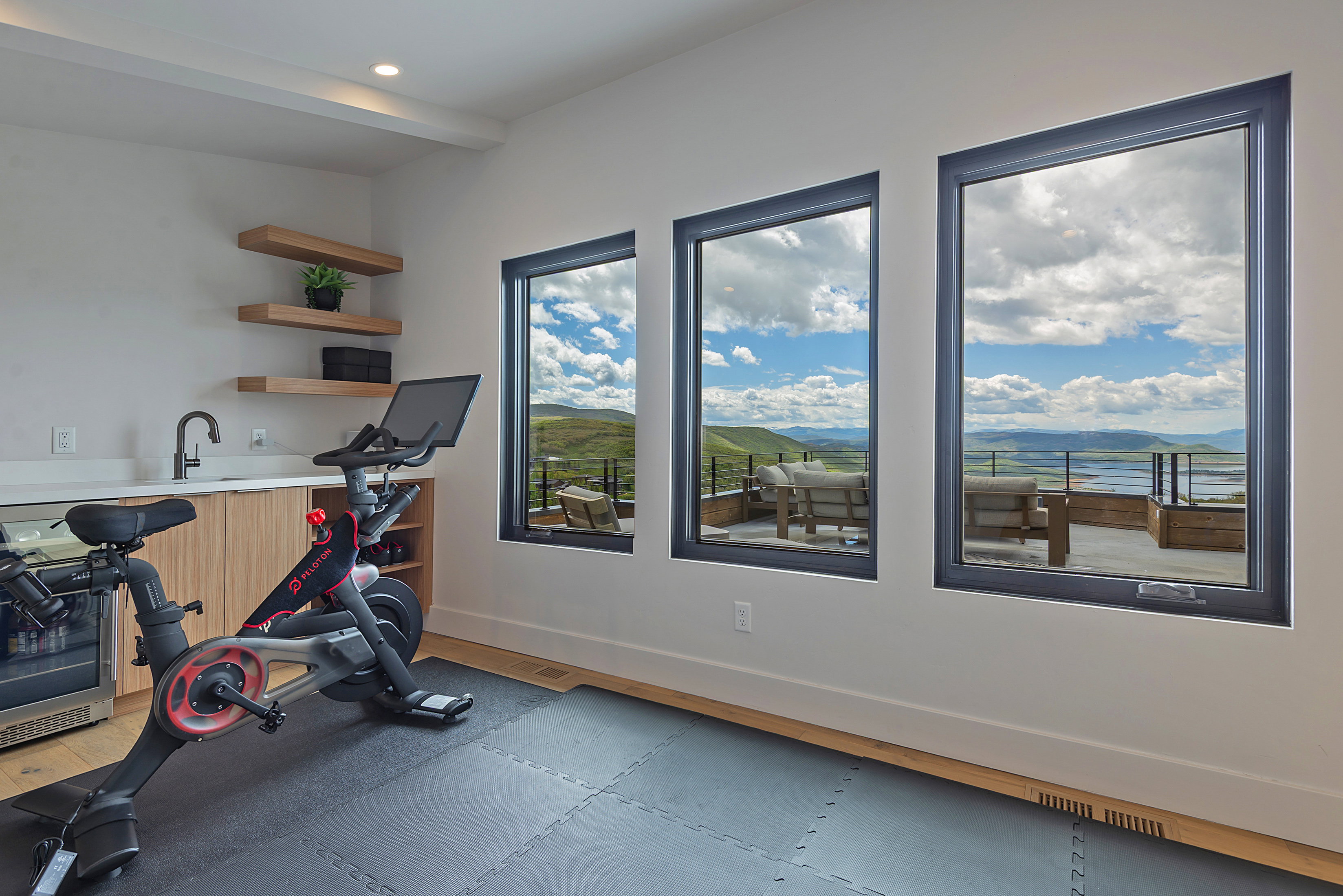 Expansive windows showcasing panoramic mountain and water scenery