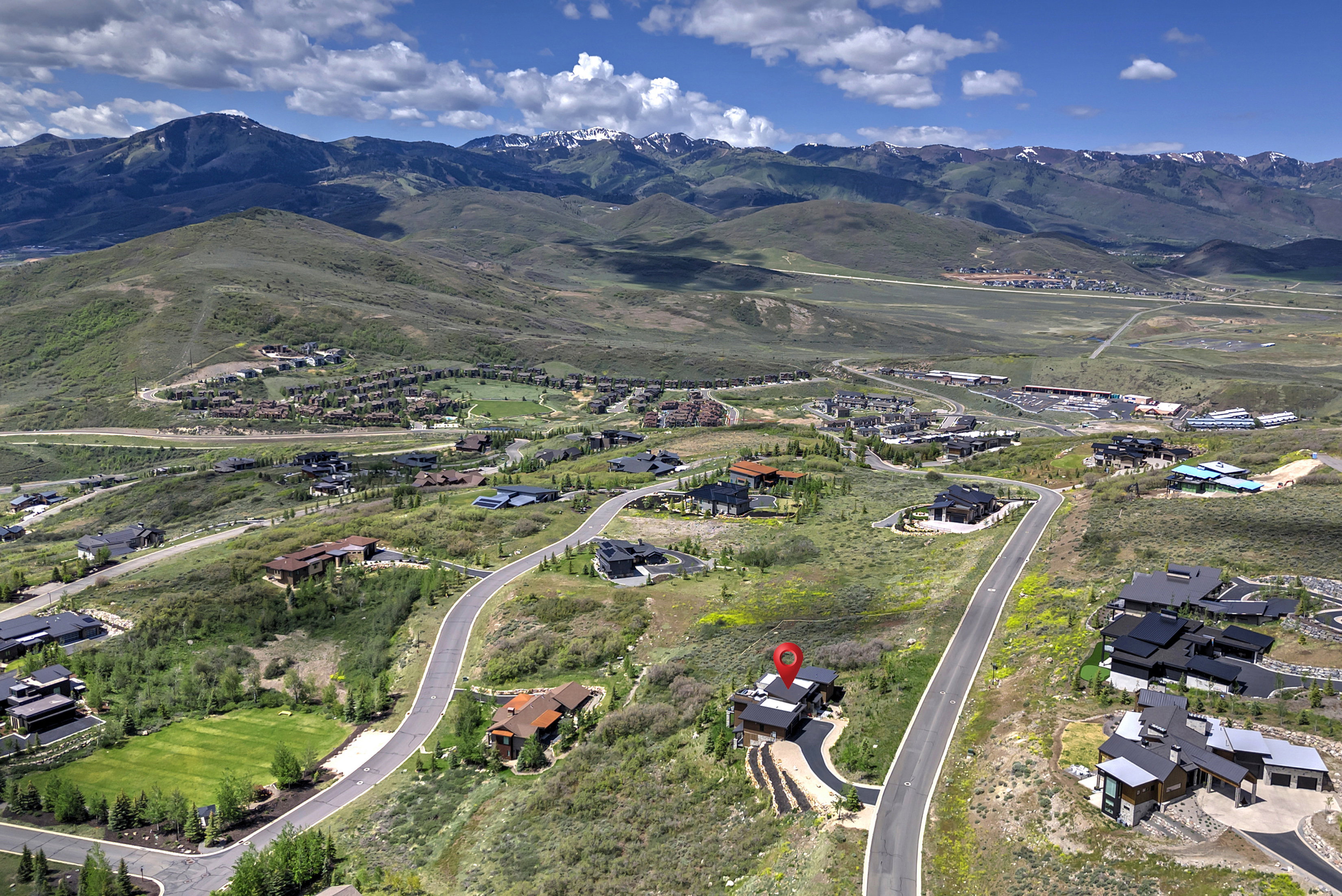 Property situated on a winding paved road with mountain scenery