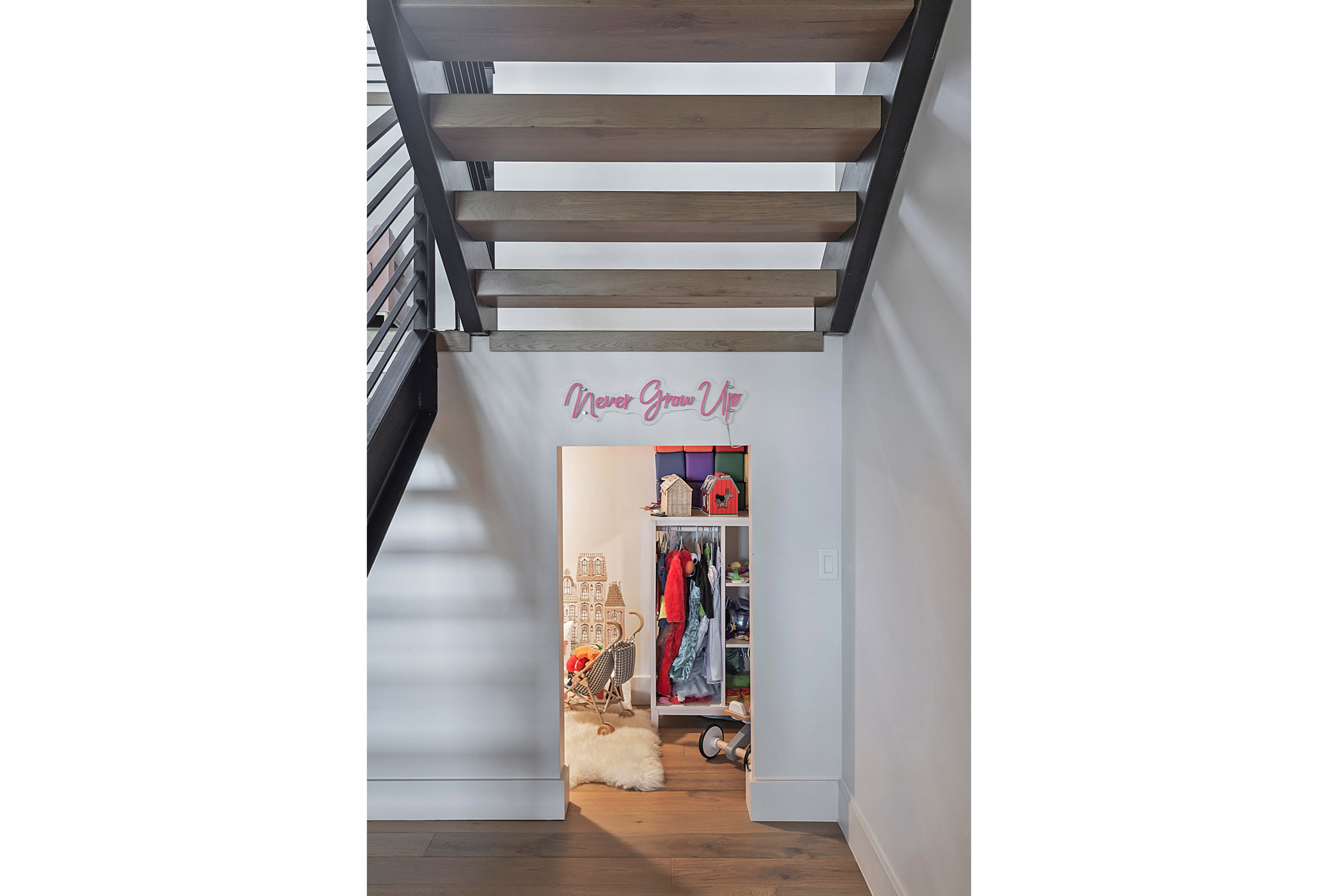 Open-tread staircase with wood-finish steps and black metal railings