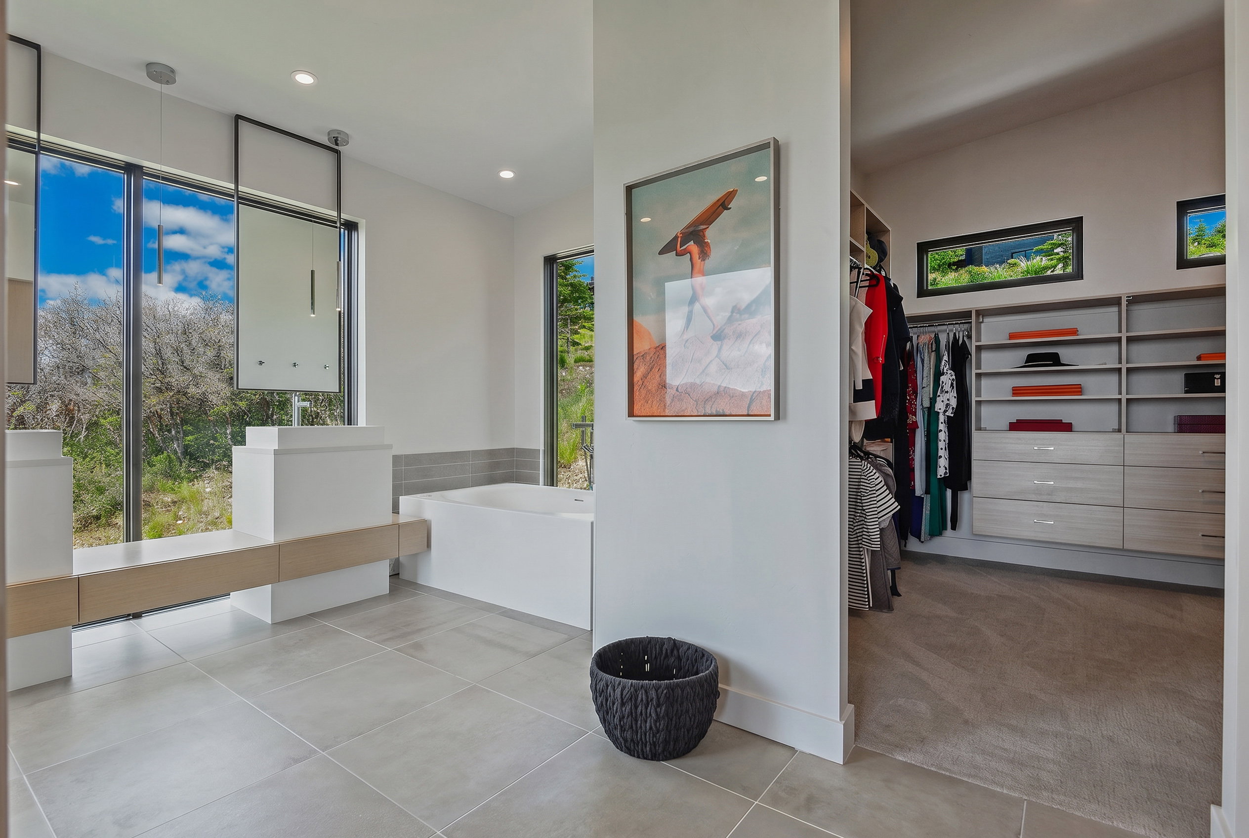 Bathroom featuring a contemporary freestanding soaking tub and two modern floating vanities with vessel sinks