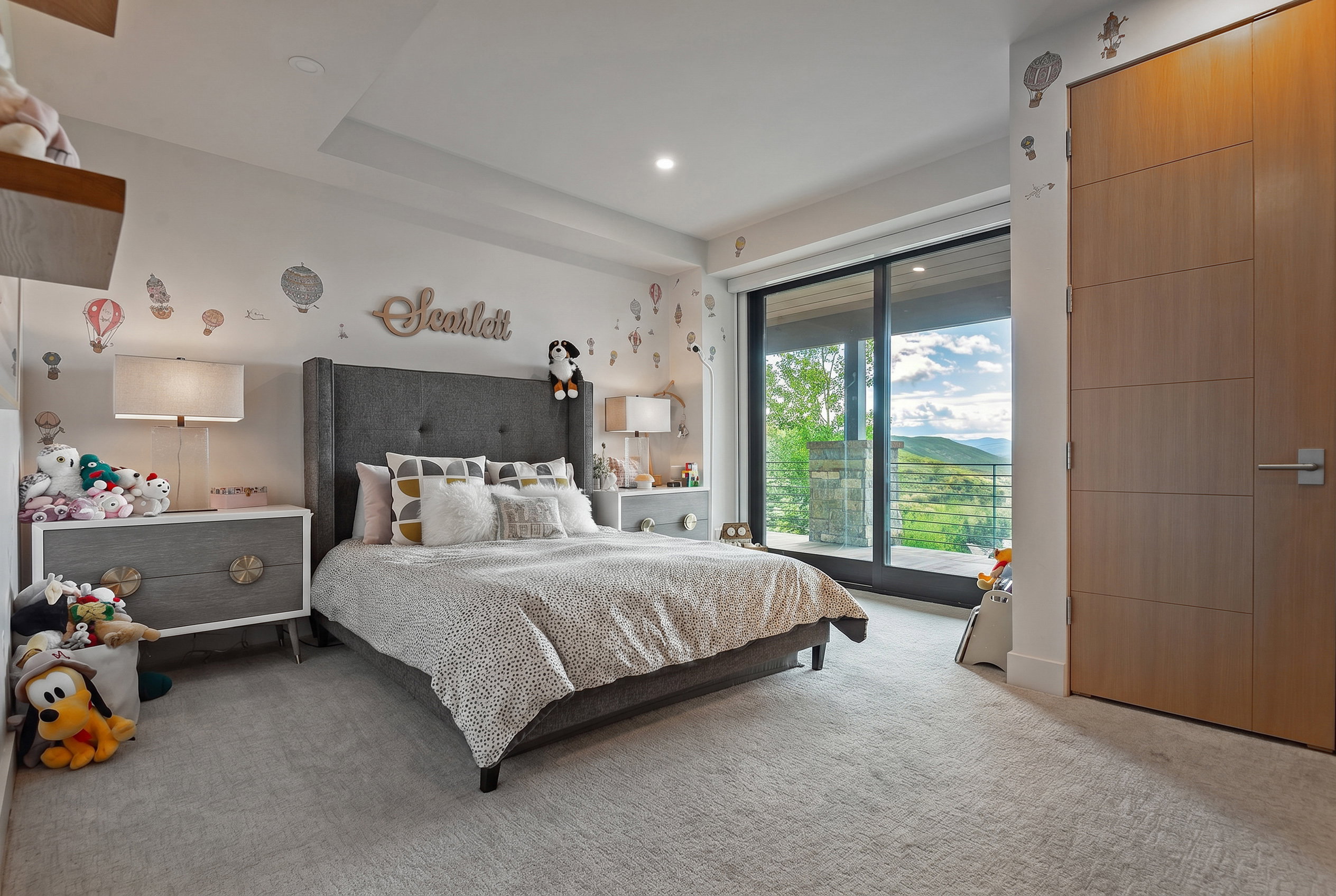 Carpeted room featuring a large sliding glass door, recessed lighting, and a solid core wood-finish door