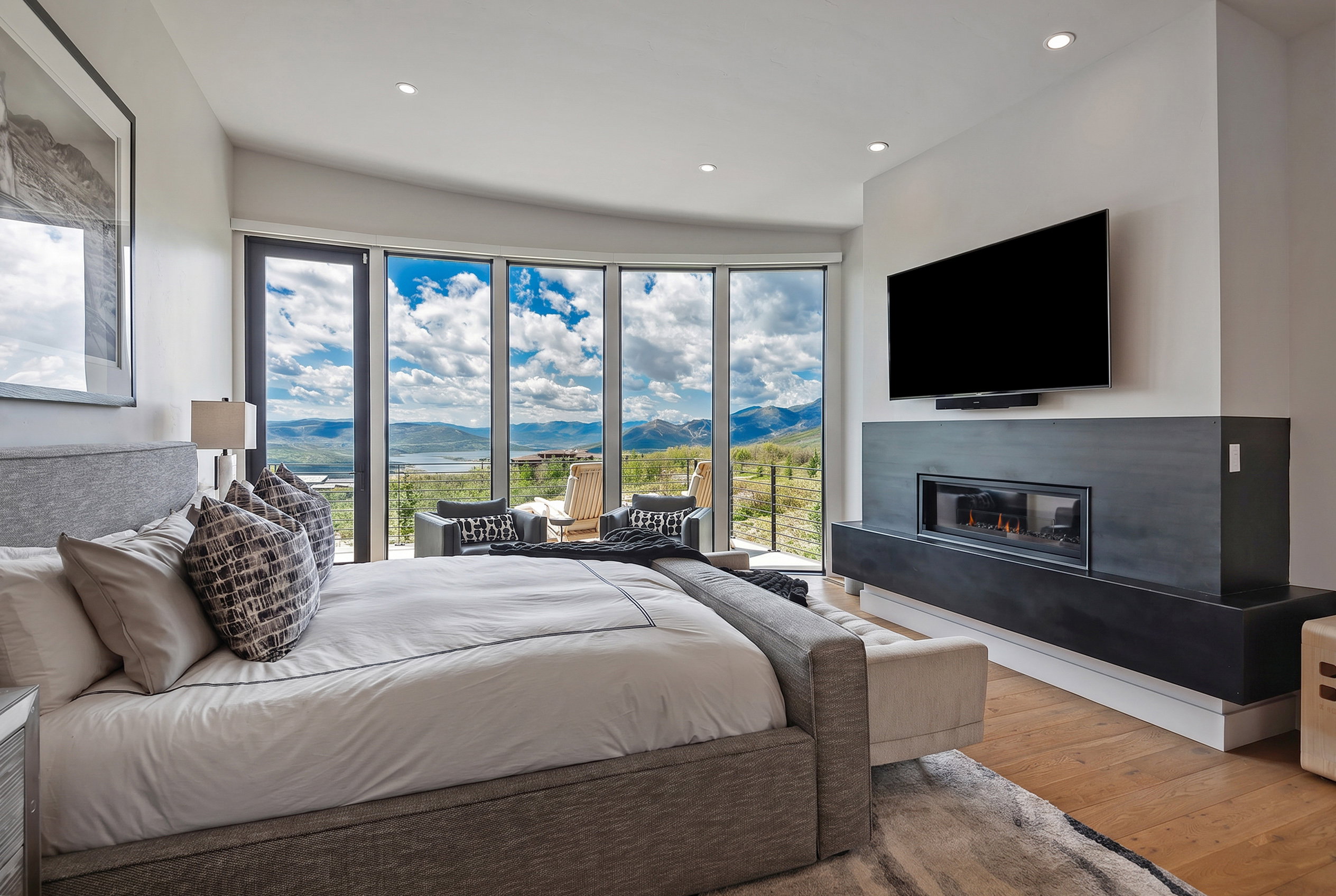 Expansive floor-to-ceiling windows featuring mountain and cloud scenery