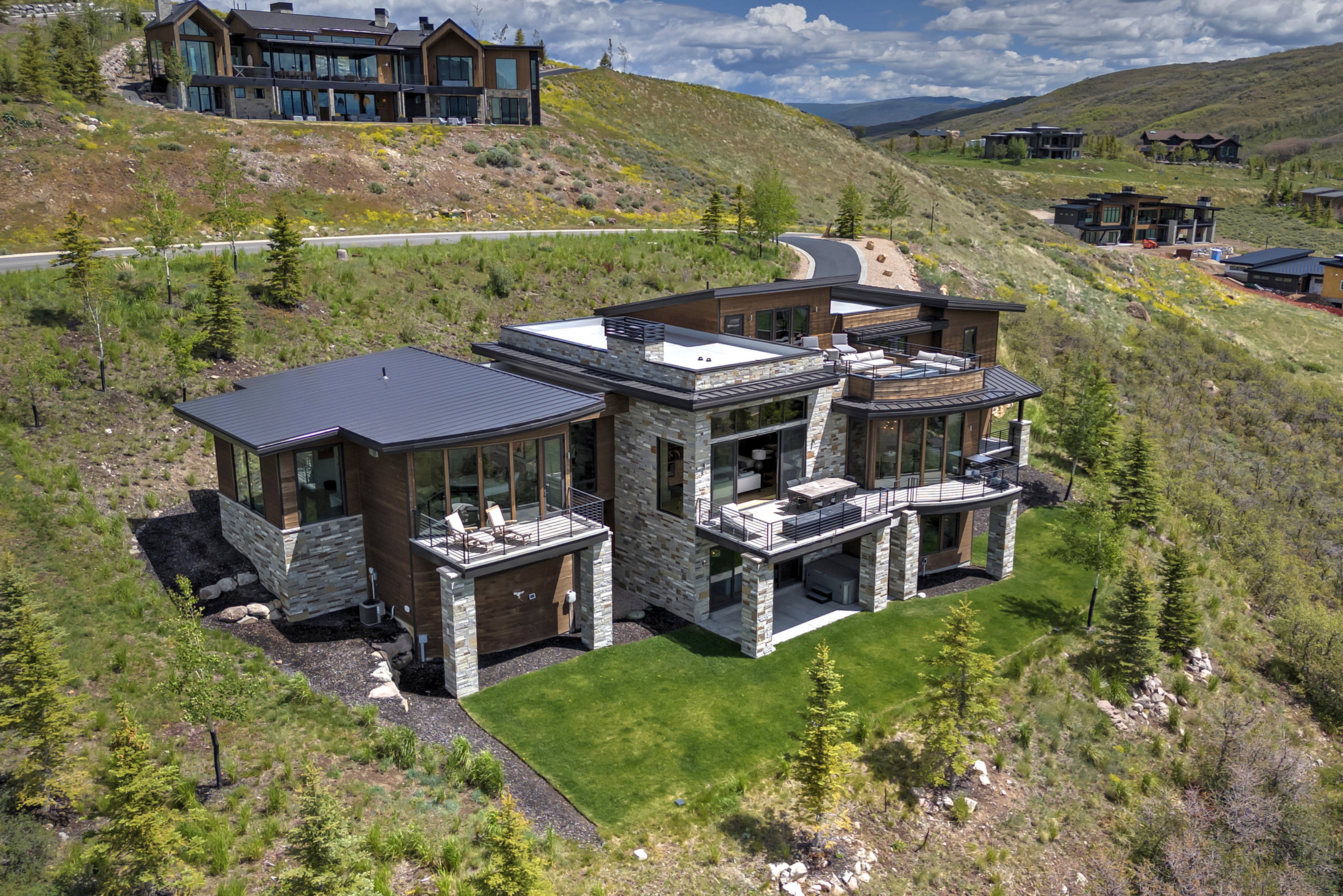 Contemporary multi-level residence featuring extensive stone and wood paneling