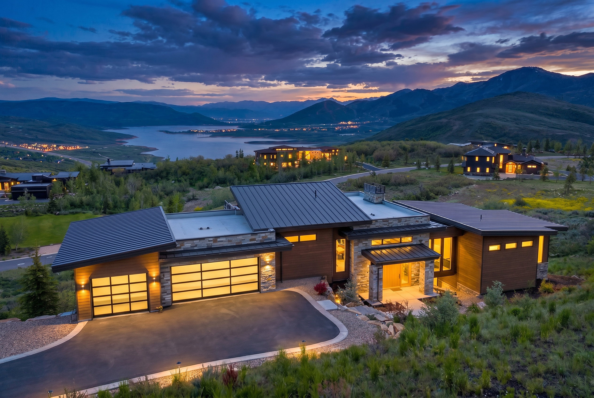 Modern architectural residence featuring multiple rooflines, wood-finish siding, and stone accents