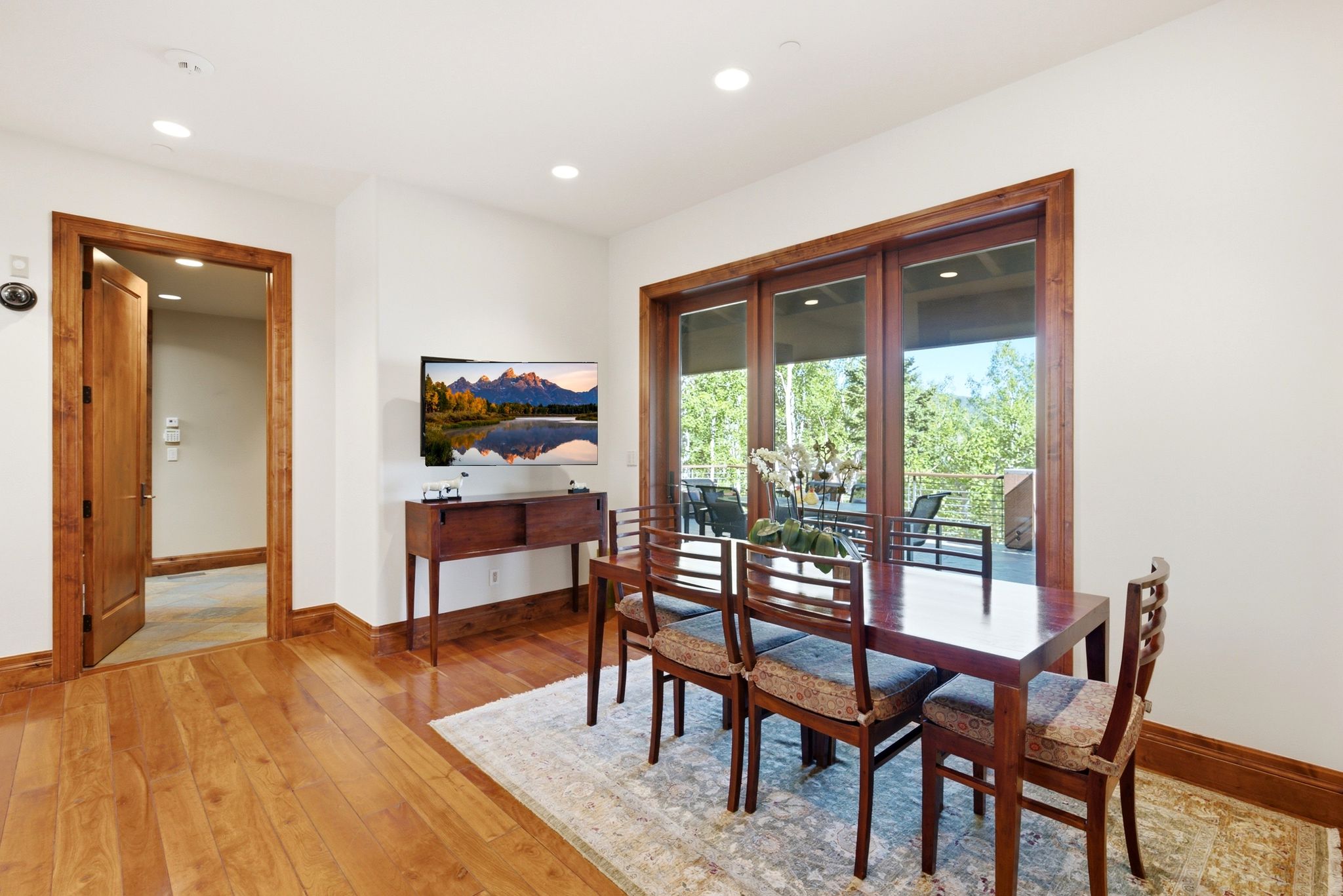 Warm wood-finish flooring extending from the entryway