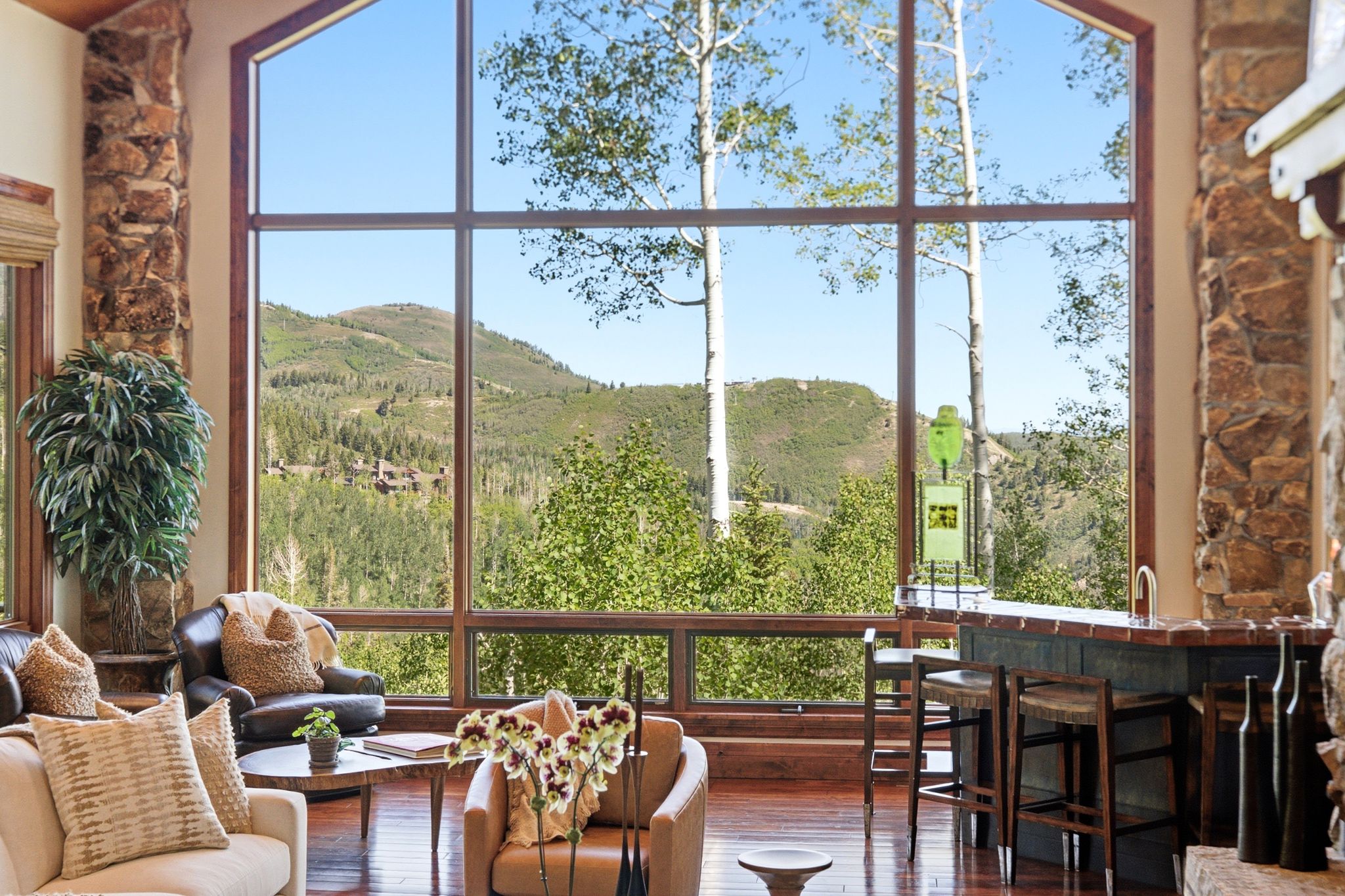 Floor-to-ceiling windows with mountain and tree scenery