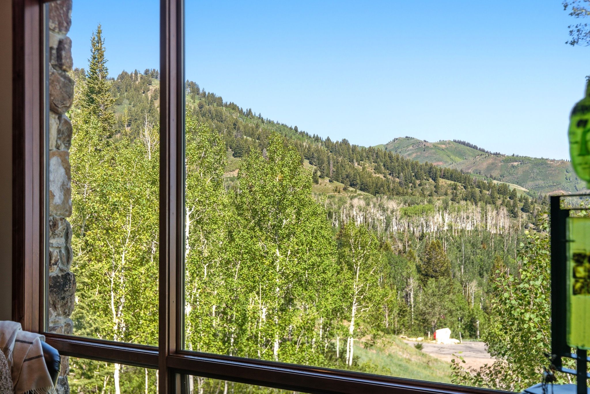Window framing mountain and forest scenery