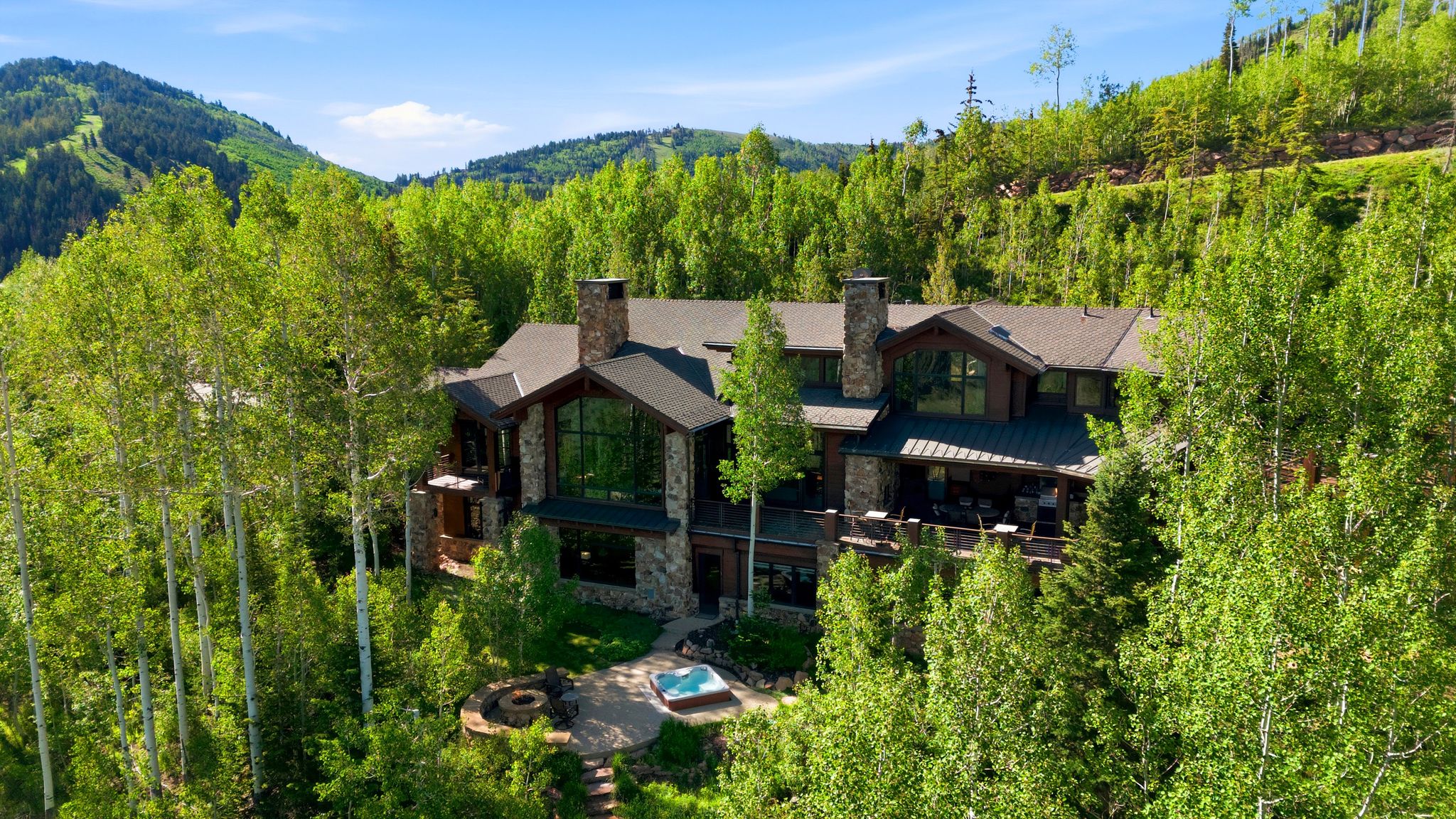 Stone and wood-clad exterior with a dark-pitched roof