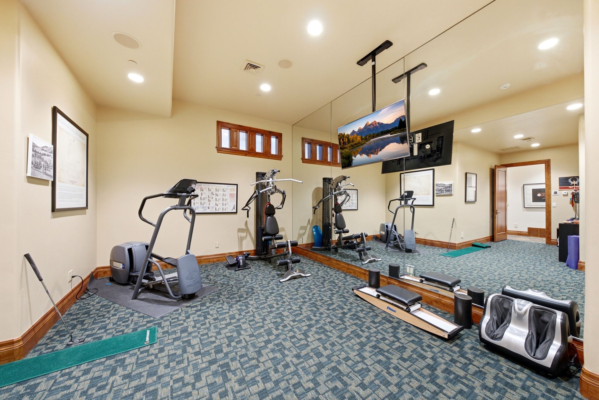 Dedicated fitness space featuring patterned carpet flooring, recessed lighting, and a mirrored wall