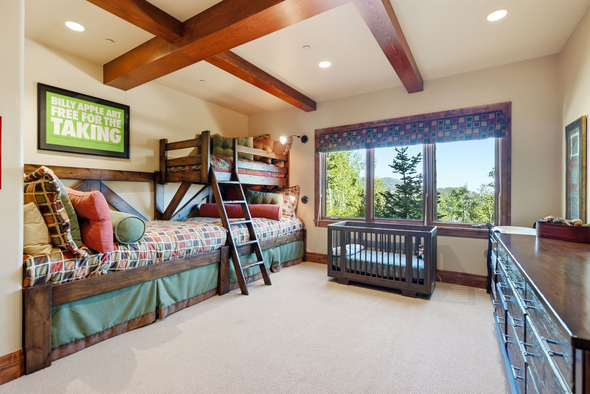 Interior room featuring exposed wood ceiling beams, a large window with wood trim, built-in bunk beds, recessed lighting, and carpeting