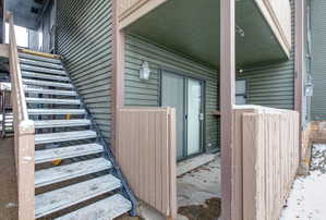 Ground-level patio area featuring privacy fencing and direct exterior access