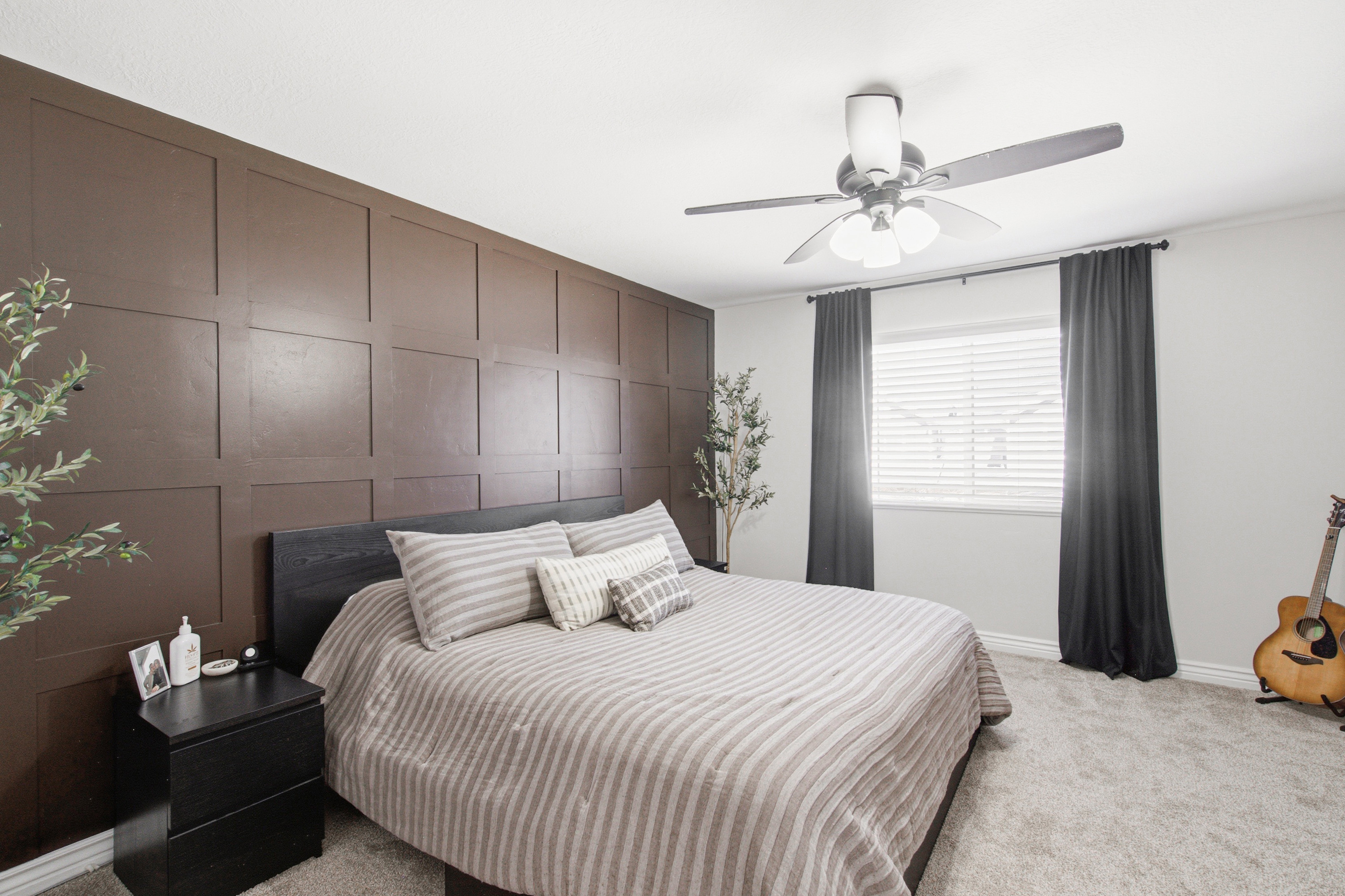 Accent wall featuring dark brown wainscoting