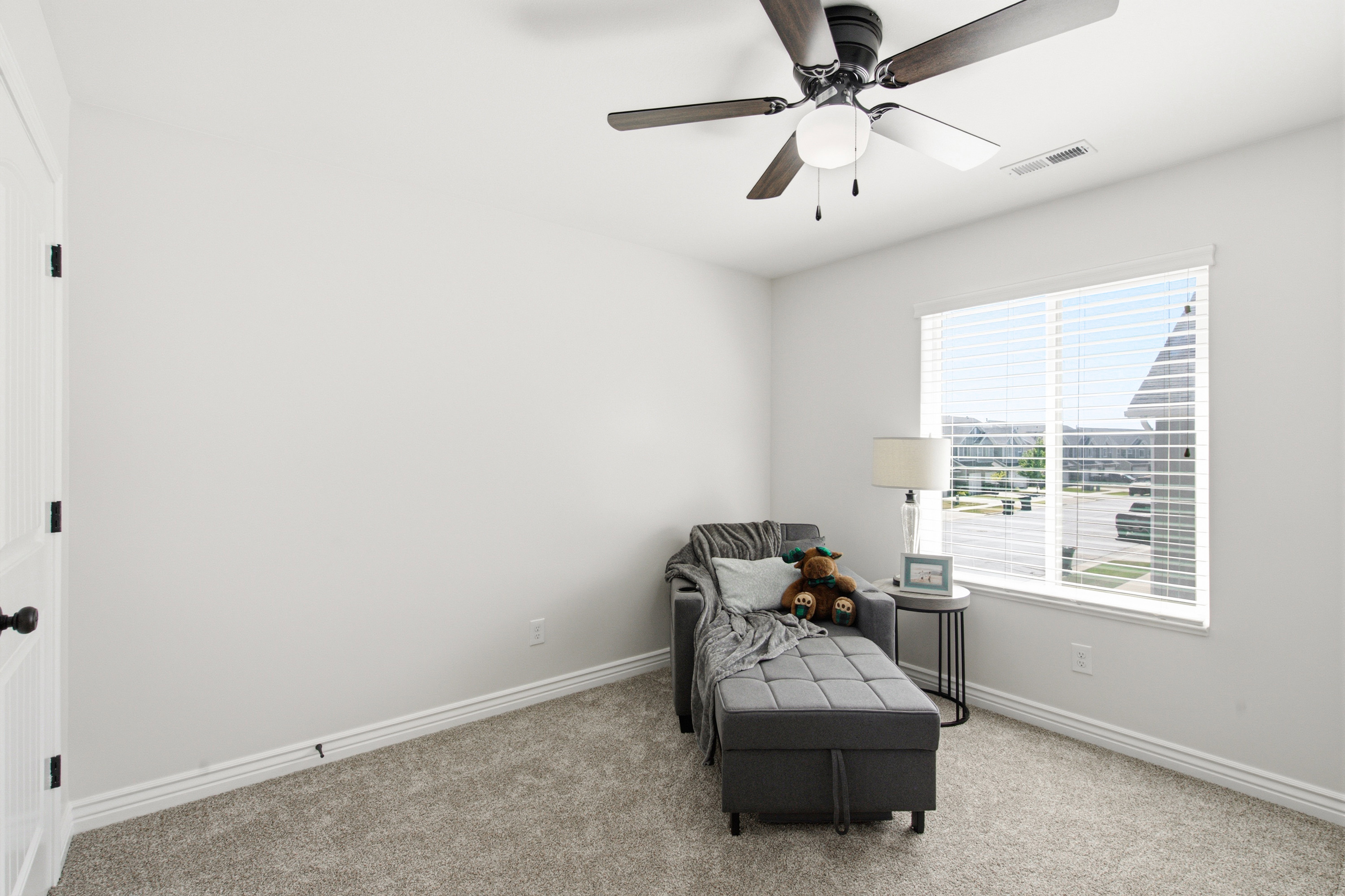 Room with light gray carpeting, neutral wall finishes, and white baseboards
