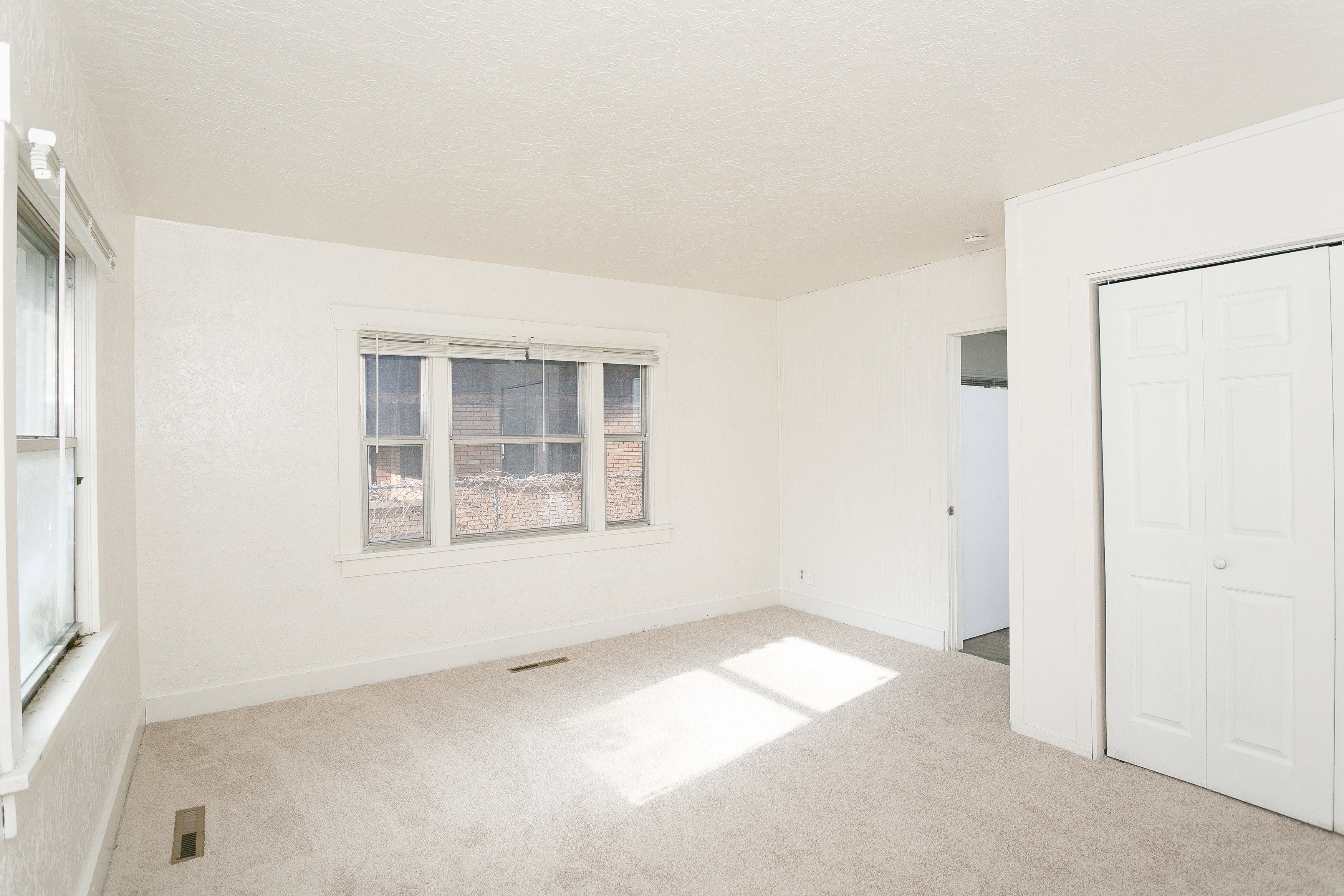Interior room featuring light-colored carpeting and white walls