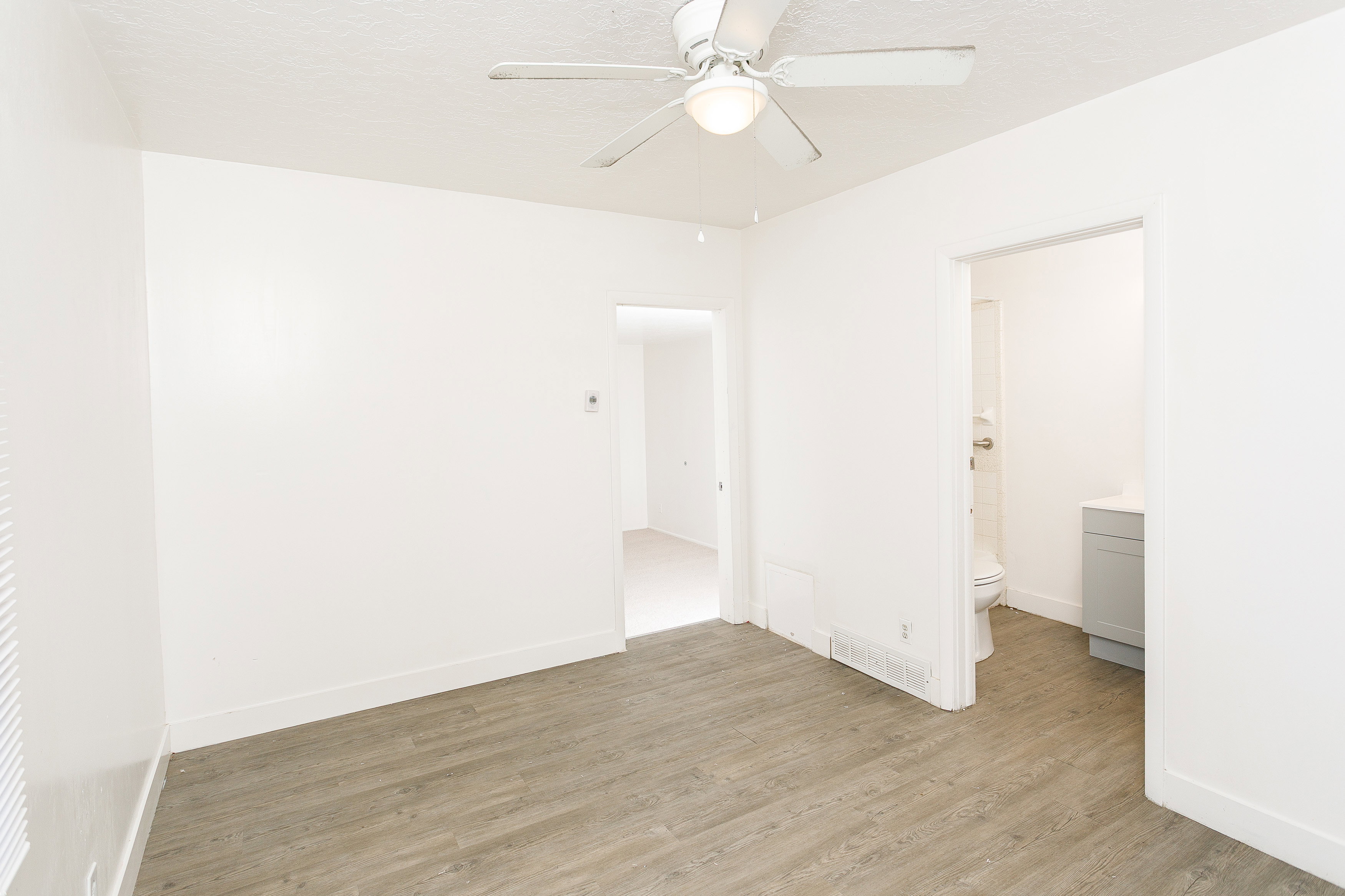 Interior space featuring wood-finish flooring and white walls