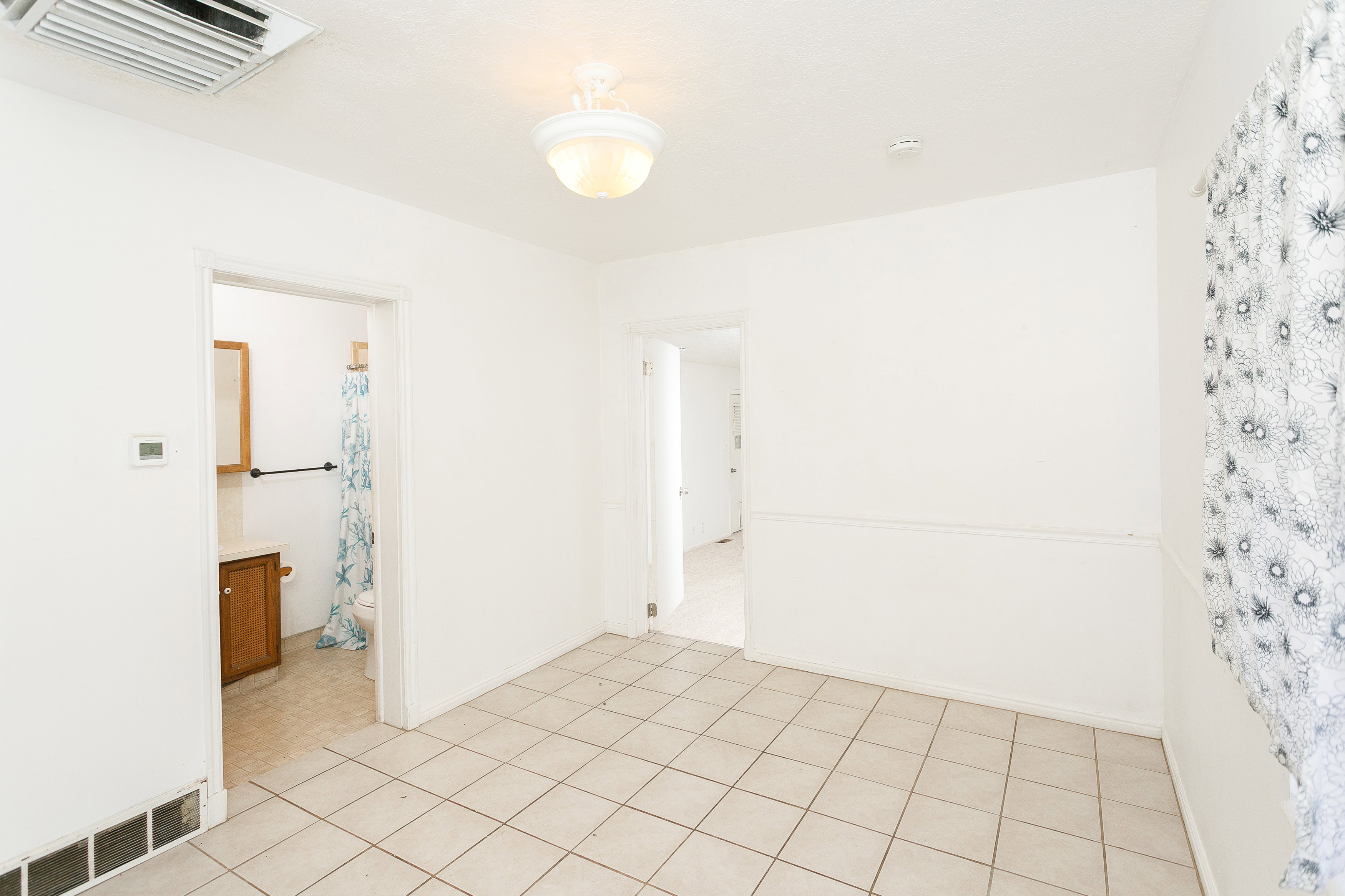 Tile flooring throughout, with a neutral wall palette