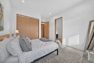 Bright room featuring light wood-finish sliding closet doors, recessed lighting, and light-toned flooring