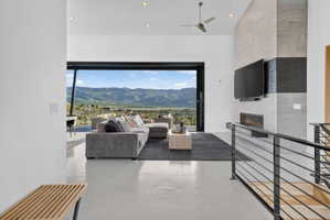 Open-concept living space featuring high ceilings, recessed lighting, and polished concrete flooring