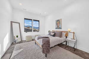 Bright room featuring a large window, recessed lighting, and a durable concrete-finish floor