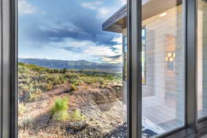 Expansive window framing a mountainous landscape with natural desert flora