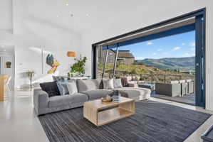 Expansive living area with large format flooring and vaulted ceilings