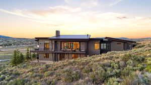 Contemporary residence featuring a dark-toned exterior with a metal roof