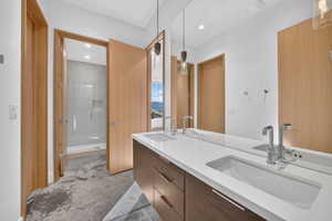 Double vanity with integrated rectangular sinks, chrome faucets, and a large frameless mirror
