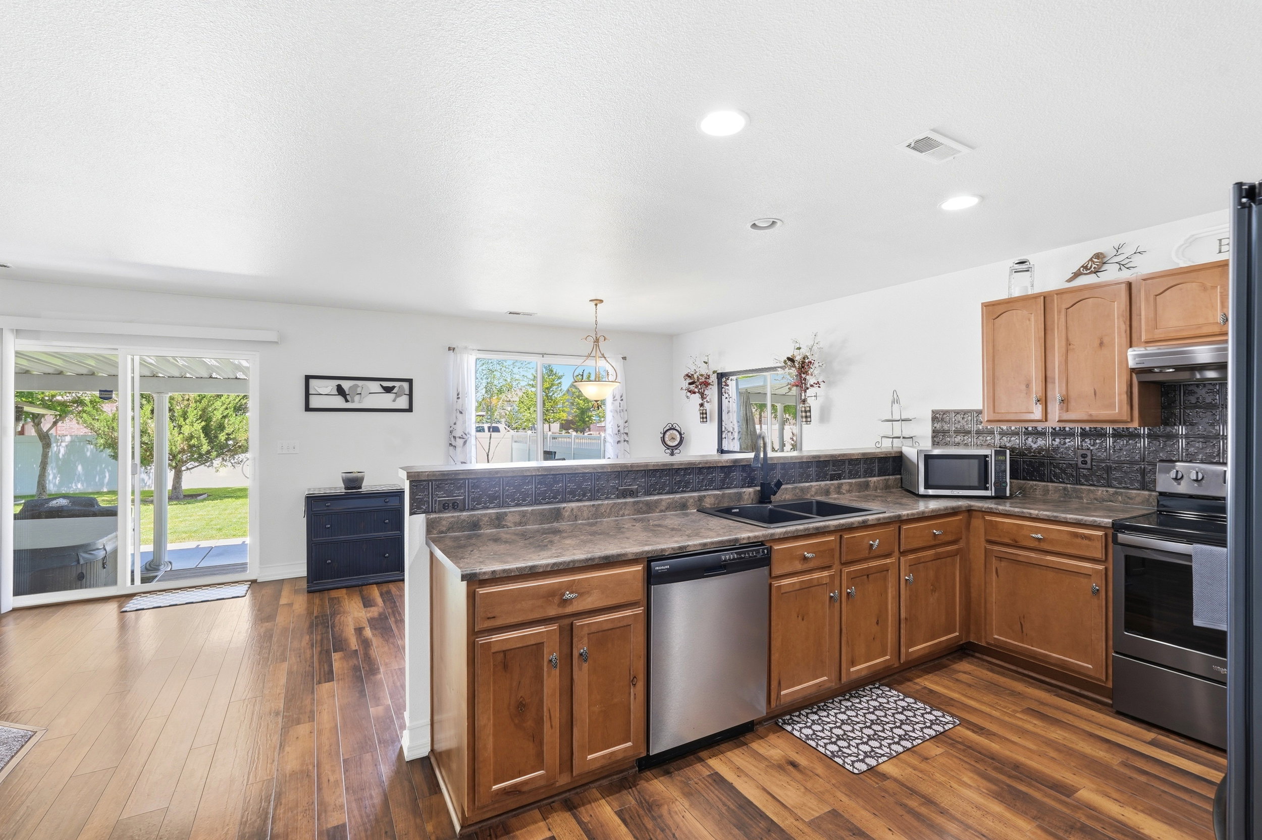 Kitchen featuring wood-finish flooring, recessed lighting, and sliding glass doors to the exterior
