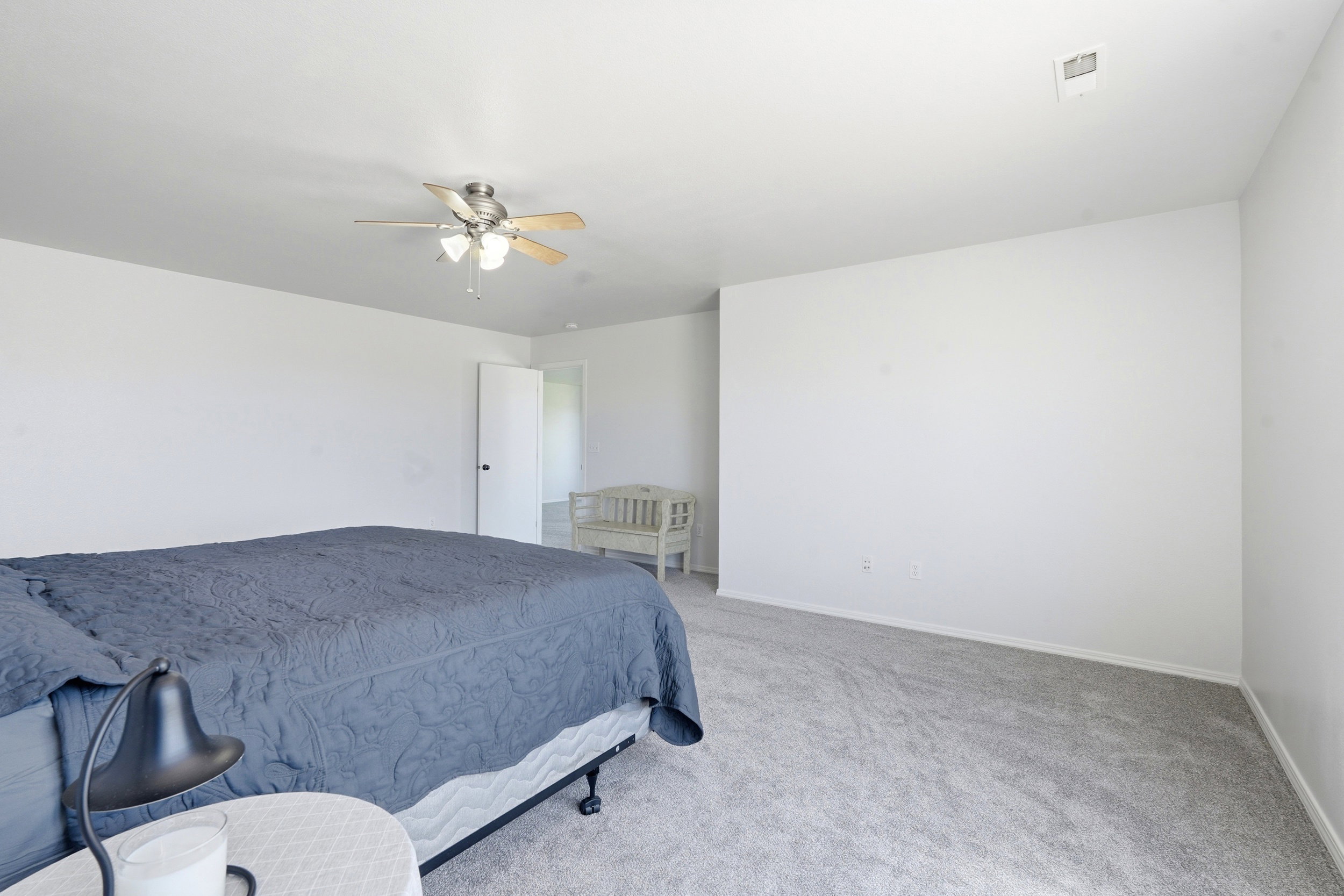Spacious room featuring light gray carpet flooring and white walls