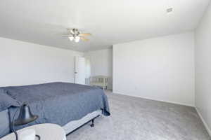 Spacious room featuring light gray carpet flooring and white walls
