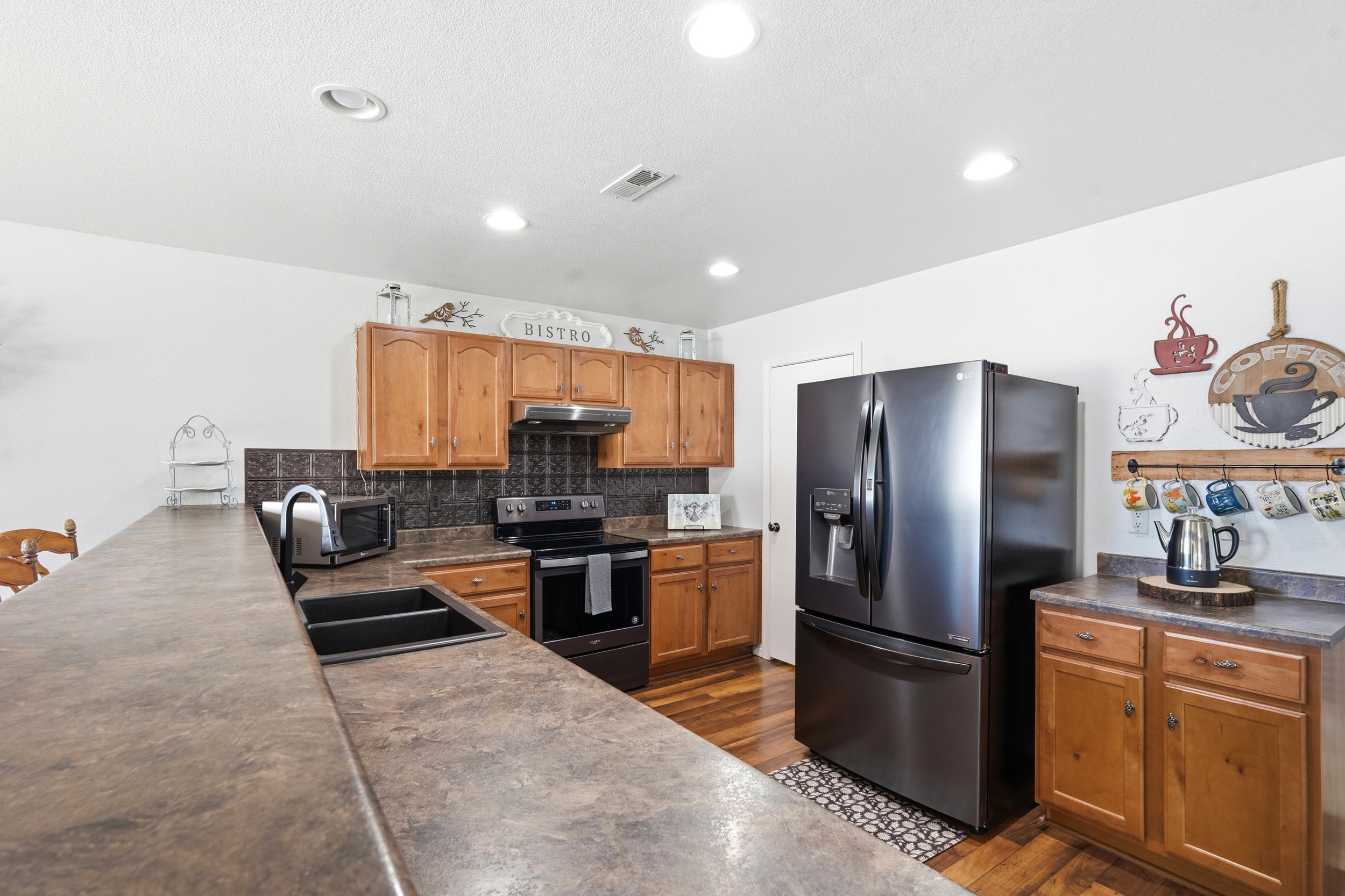 Kitchen featuring wood-finish flooring and recessed lighting