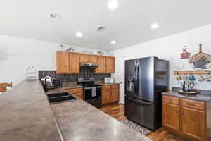 Kitchen featuring wood-finish flooring and recessed lighting