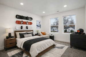 Bright room featuring two large windows, recessed lighting, and a wood-finish bed frame
