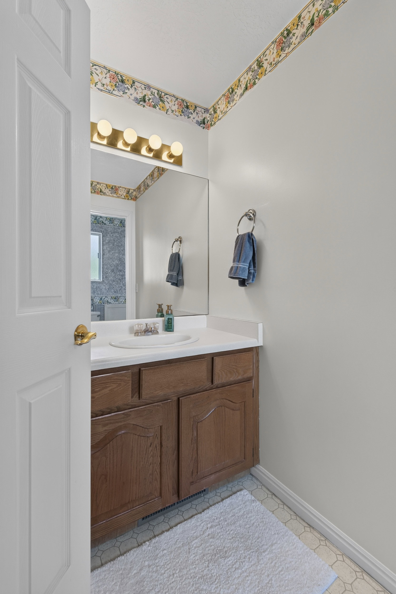 Bathroom vanity with a white countertop and integrated sink