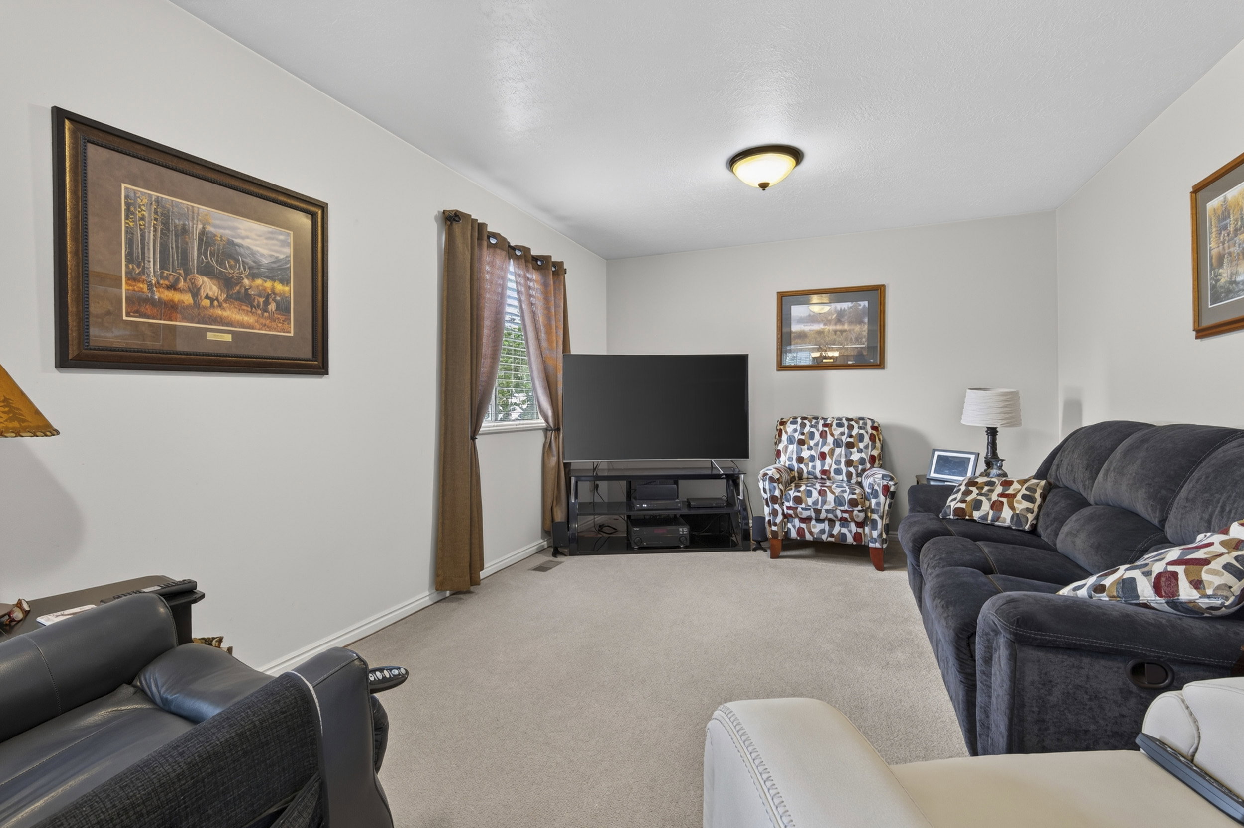 Carpeted interior space with light-toned walls and white baseboards