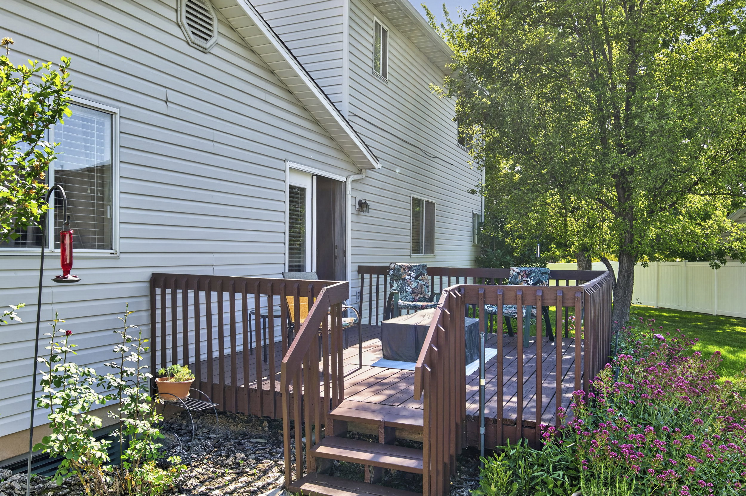 Multi-level wood deck featuring integrated railing and steps
