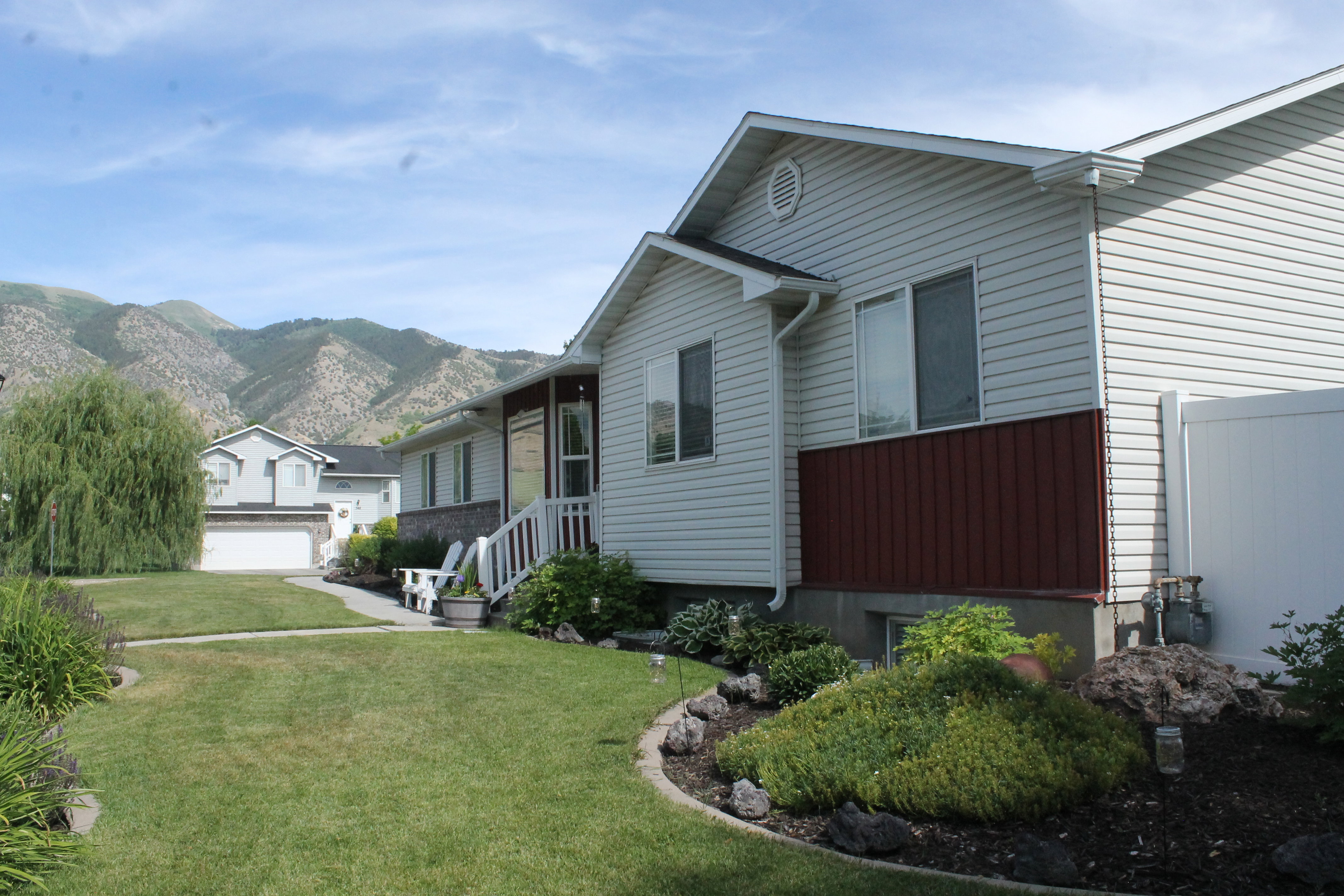 Neutral-toned siding exterior with a contrasting red accent panel