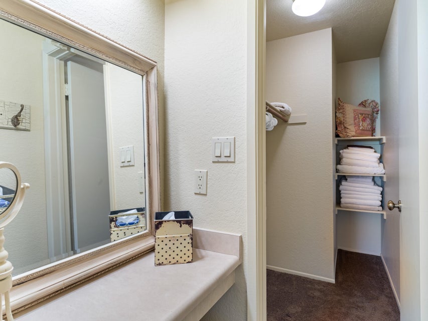 Vanity area featuring a built-in countertop and a large framed wall mirror