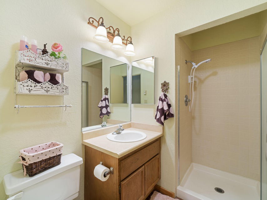 Bathroom featuring a stand-up shower with tiled walls and a glass enclosure
