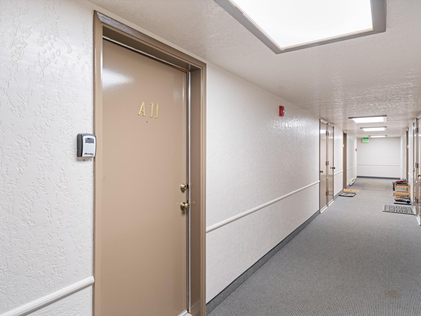 Entry door with brass hardware and numerical designation