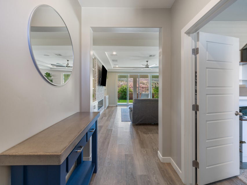 Entryway featuring wood-finish flooring and a built-in console table with a concrete-look top