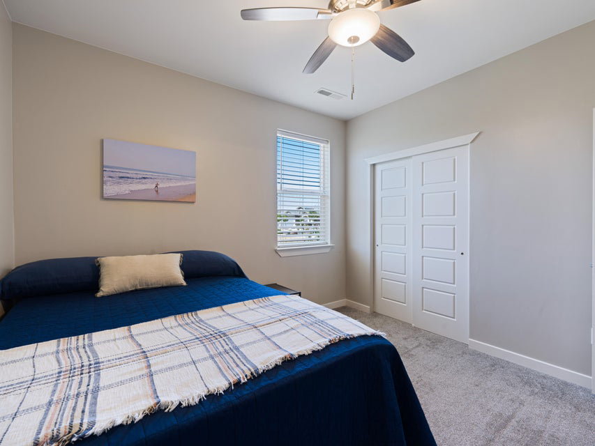 Bedroom featuring a window with blinds, light gray carpet, and light gray walls