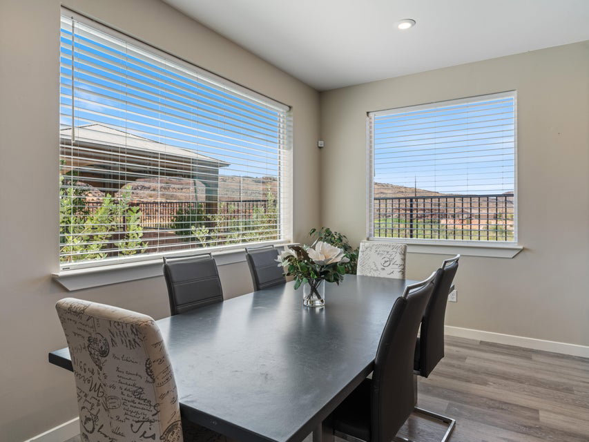 Dining area featuring expansive windows, wood-finish flooring, and recessed ceiling lighting
