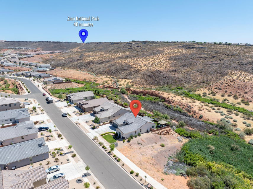 Aerial perspective showcasing a residential neighborhood with surrounding desert landscape