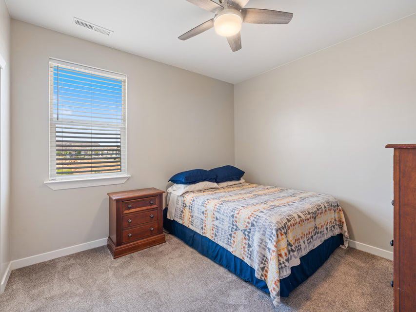 Carpeted room with a ceiling fan, recessed lighting, and a window with blinds