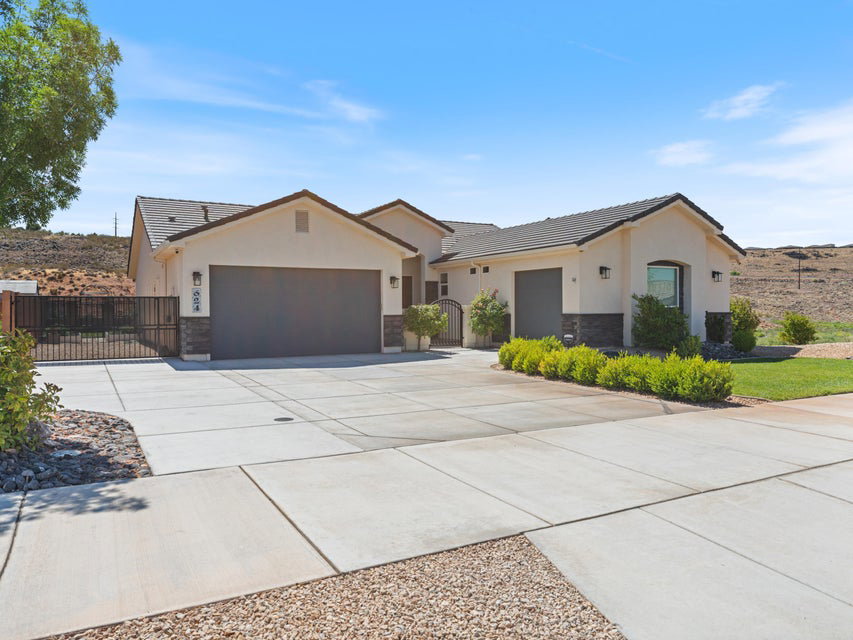 Contemporary stucco exterior with dark tile roofing and stone accents