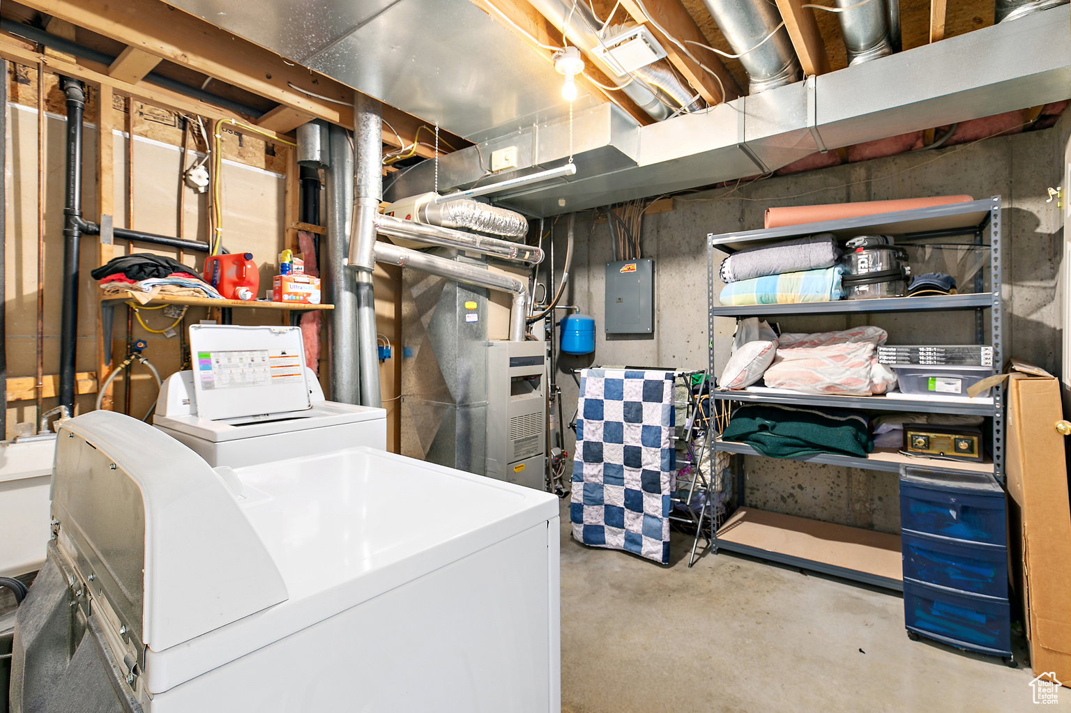Utility area with concrete flooring, exposed ceiling joists, and visible ductwork