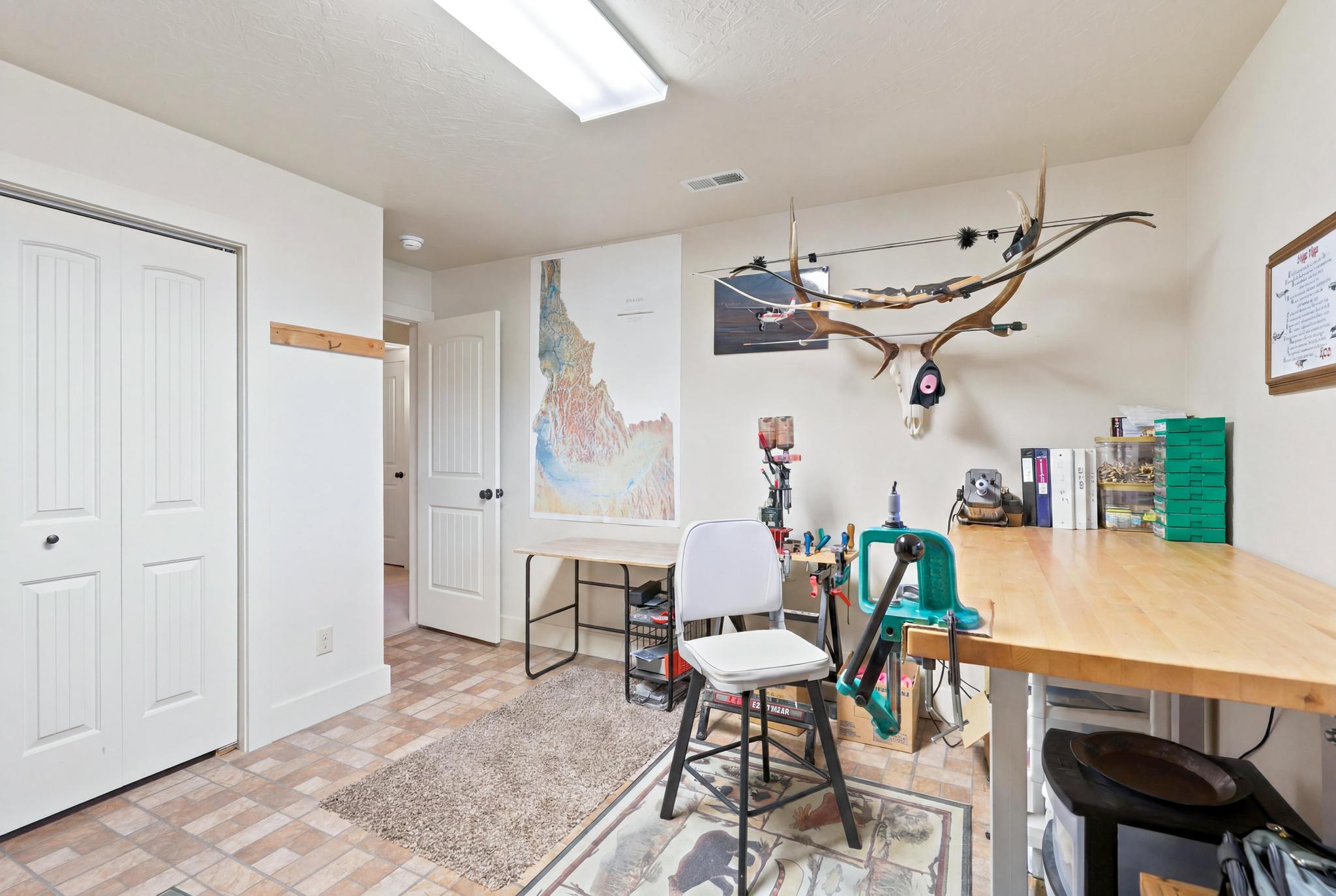 Versatile room featuring bi-fold closet doors and patterned tile flooring