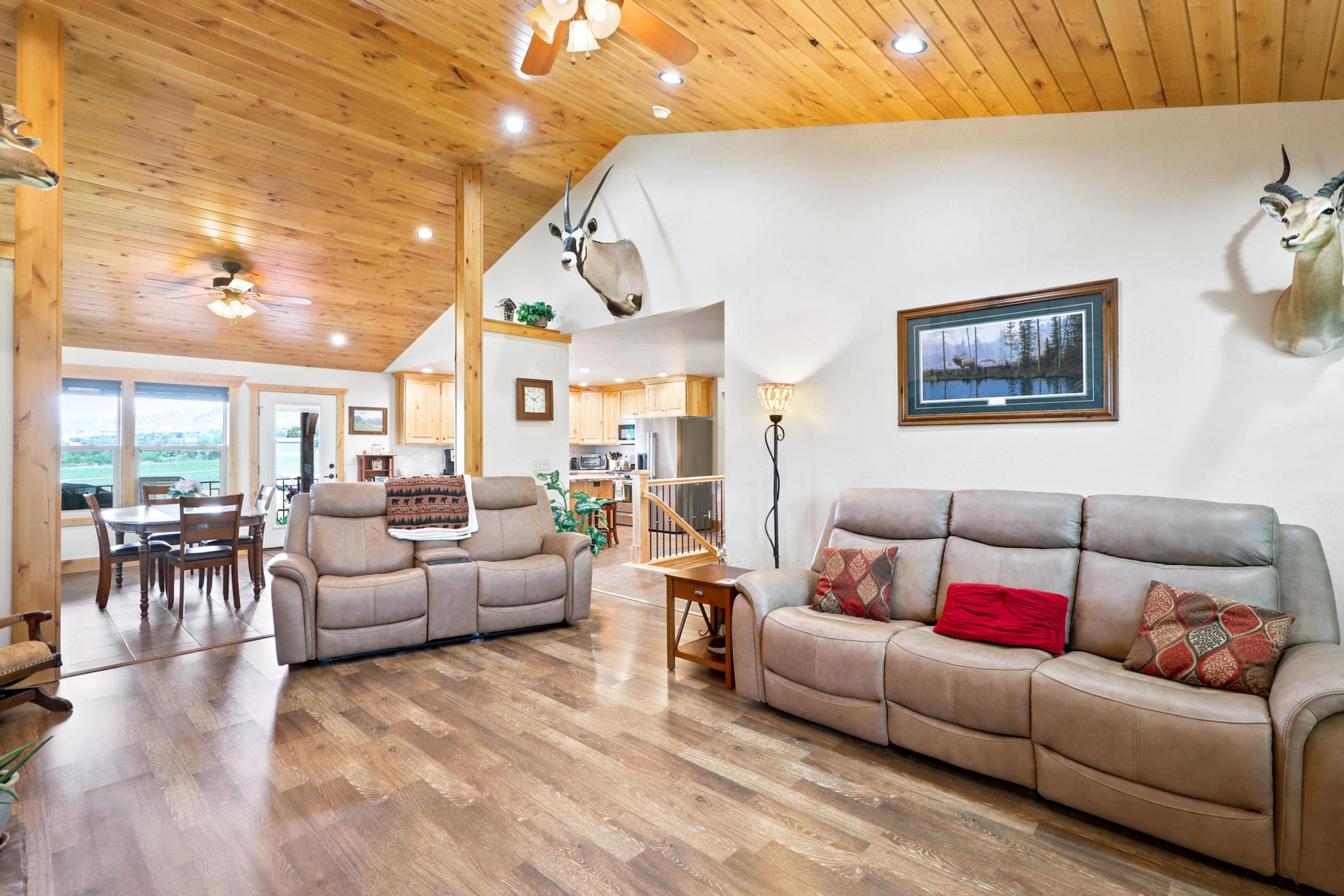 Vaulted wood-paneled ceiling with recessed lighting and ceiling fans