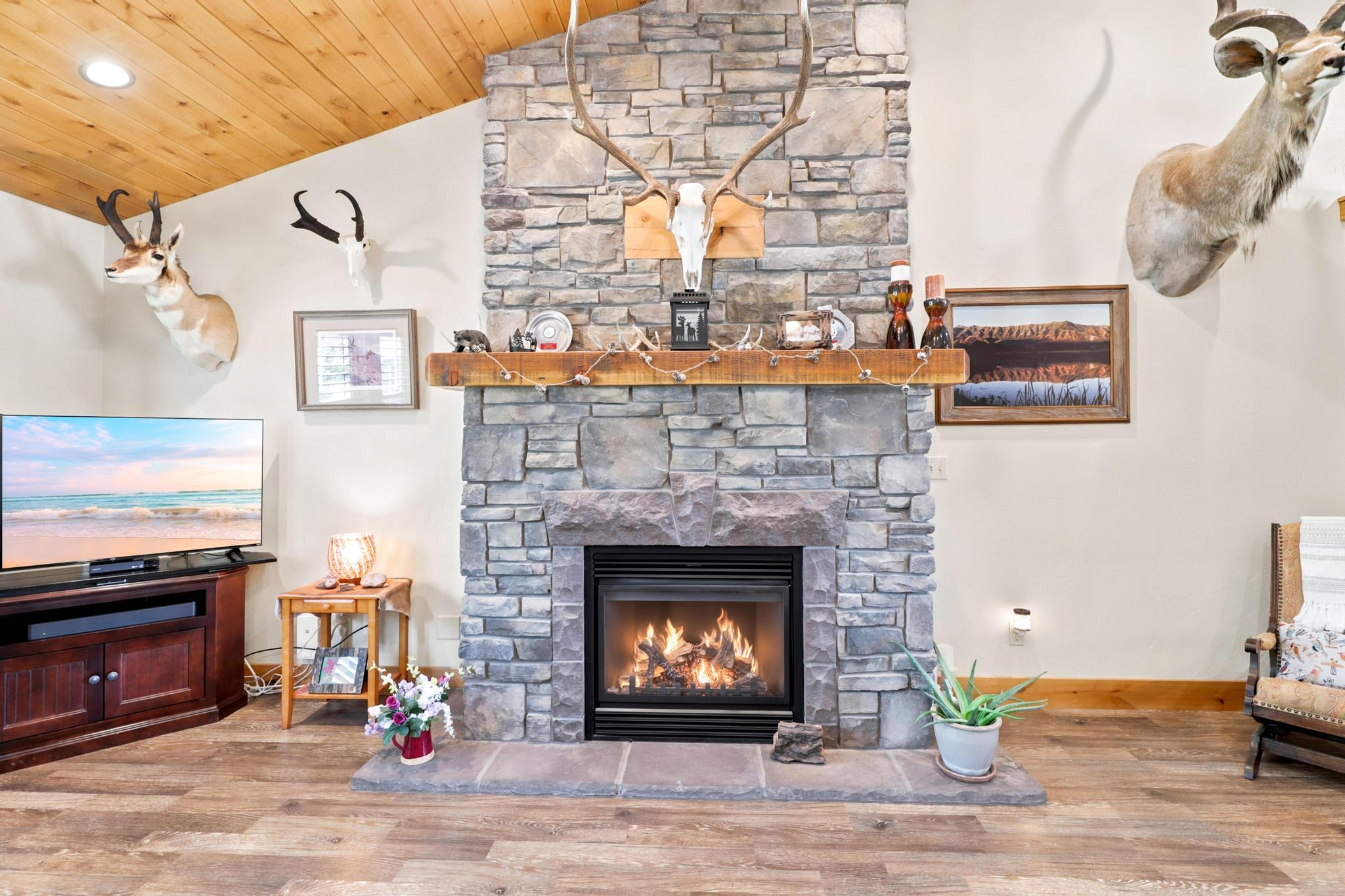 Stone-faced fireplace with a wood mantel and hearth